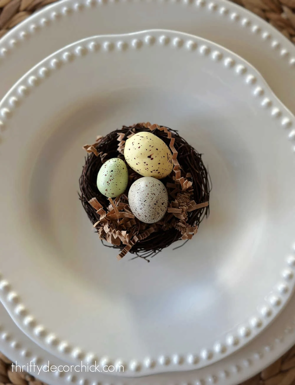 small nest with eggs on plate